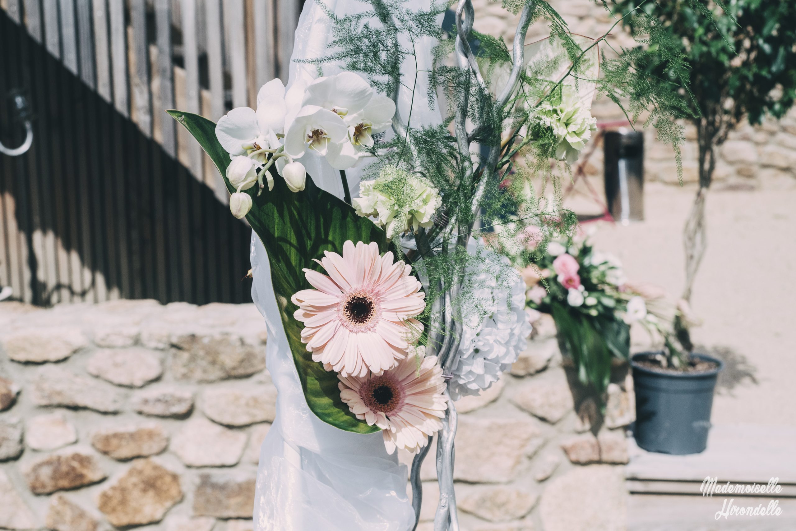 Composition florale de mariage devant les murs du domaine